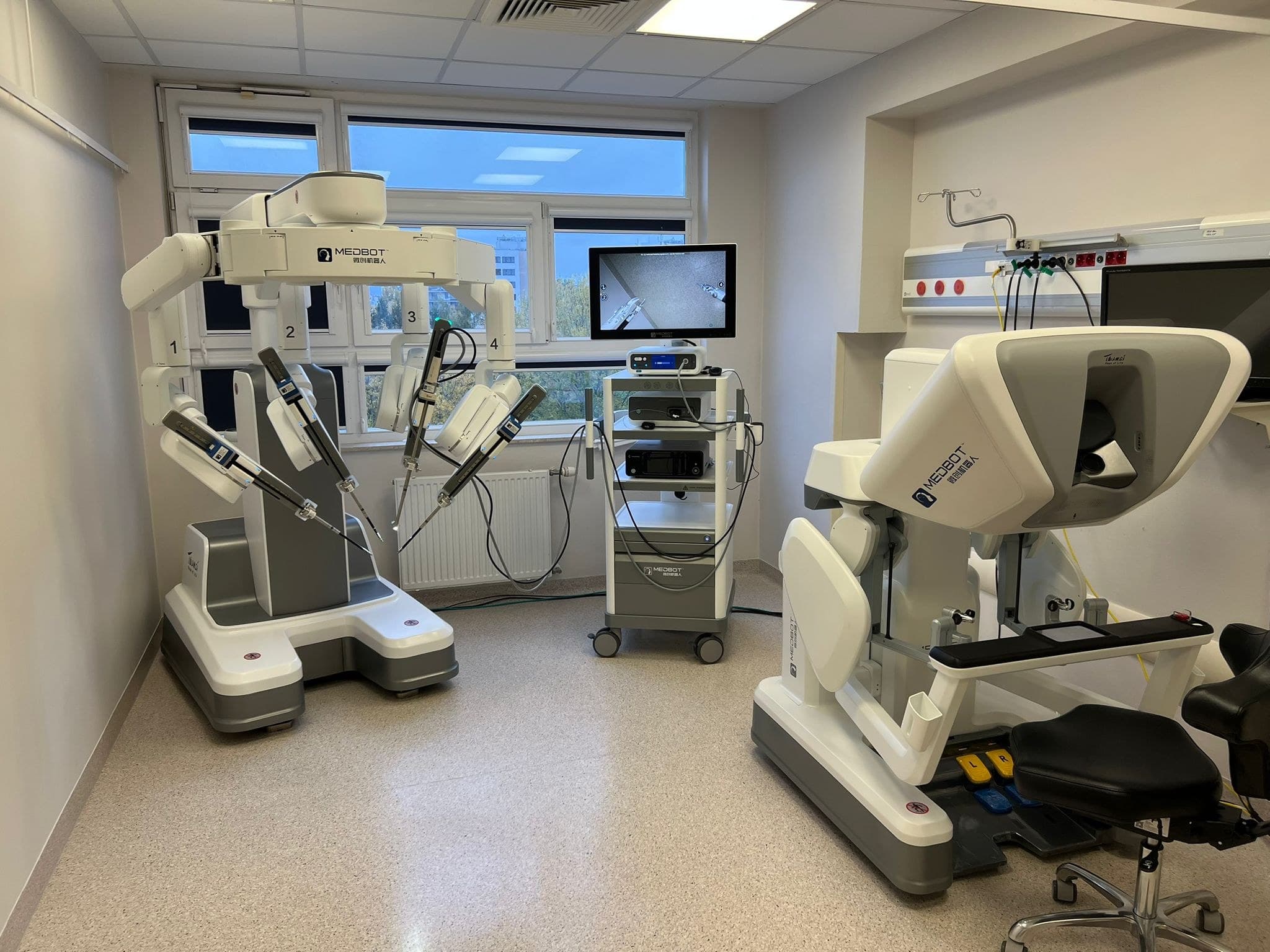 Toumai robotic surgical system with its surgeon console in a hospital room
