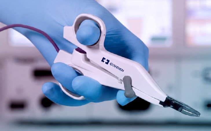 Surgeon holding an advanced surgical device