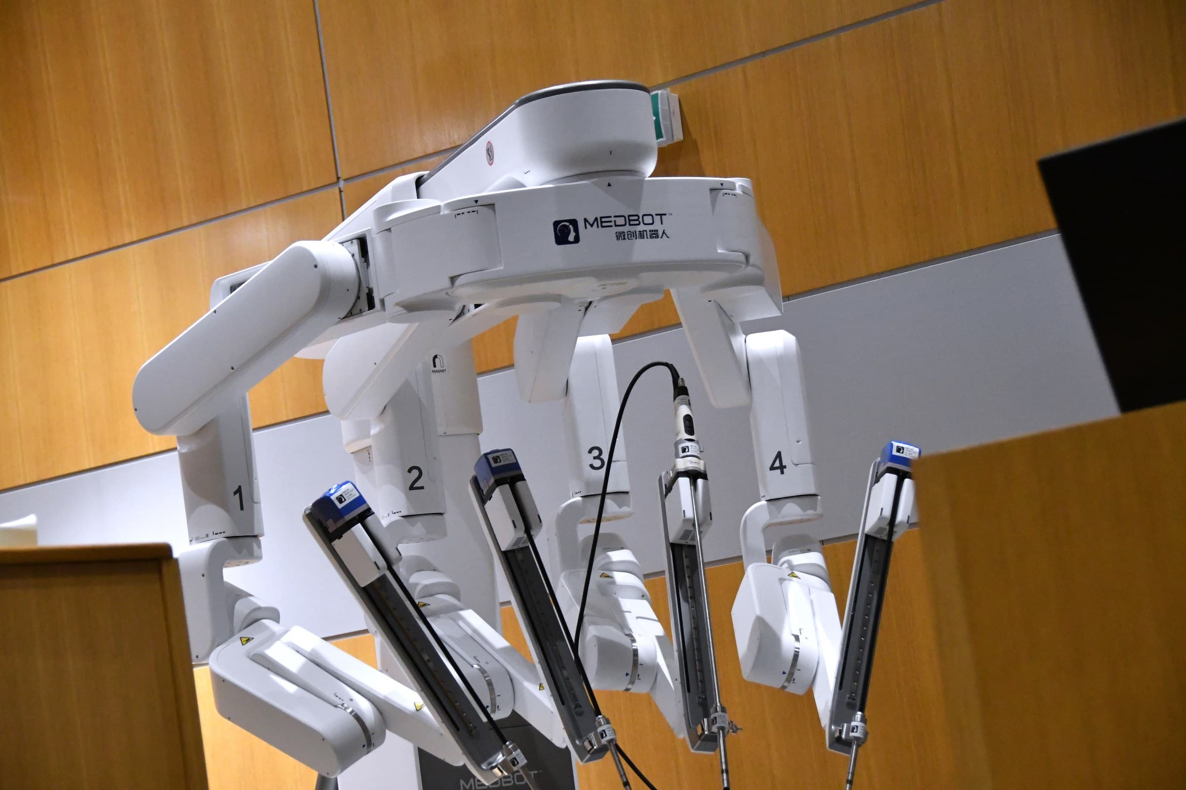 Toumai® patient cart with robotic arms in an operating room